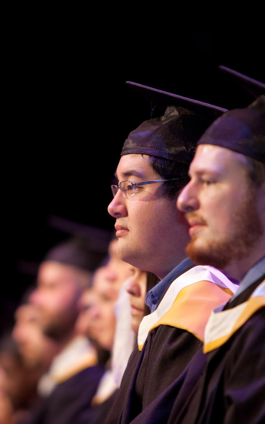 A row of students in graduation regalia
